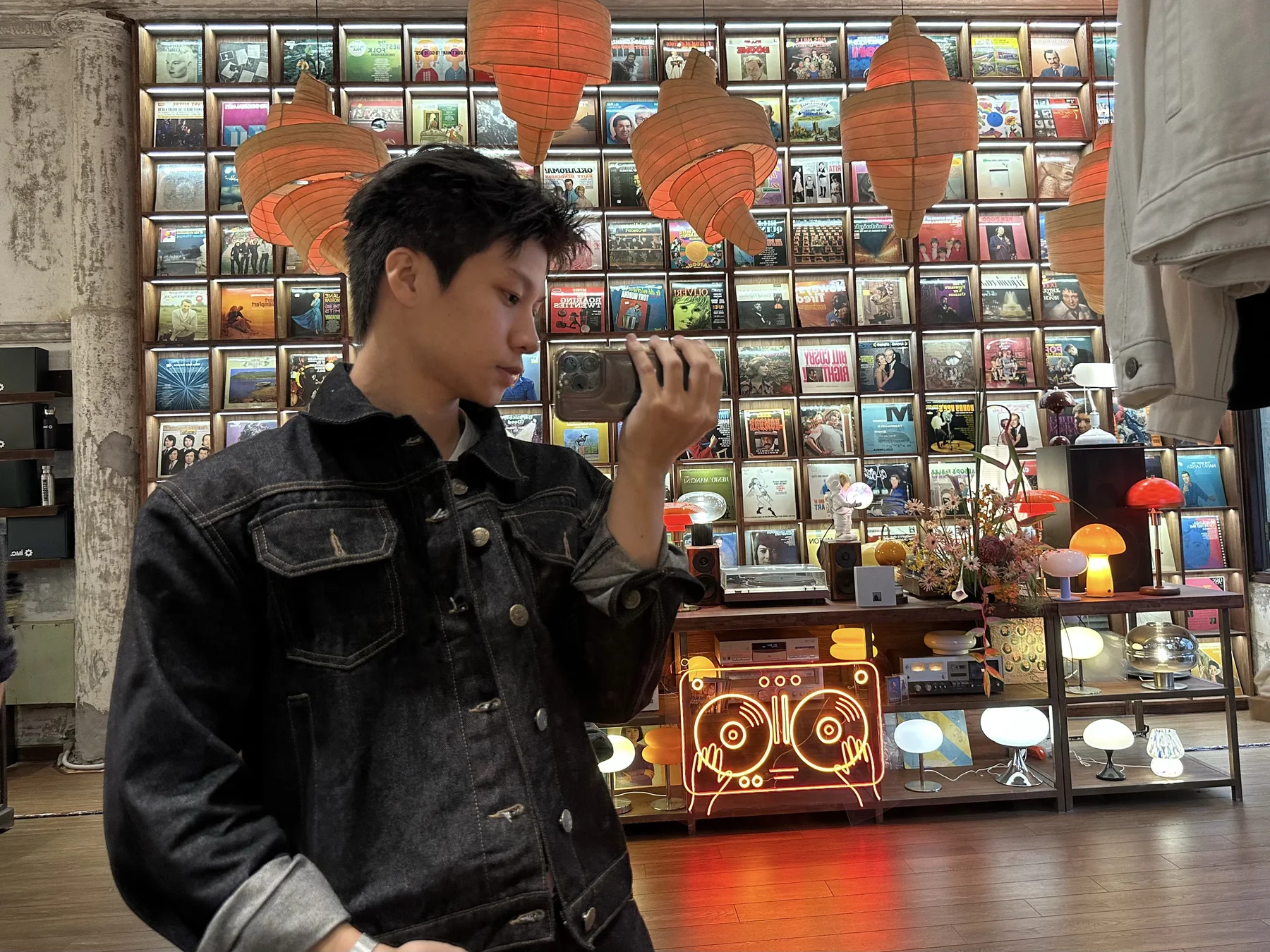 Nguyễn Khánh Hưng photographing a reflection in a record room