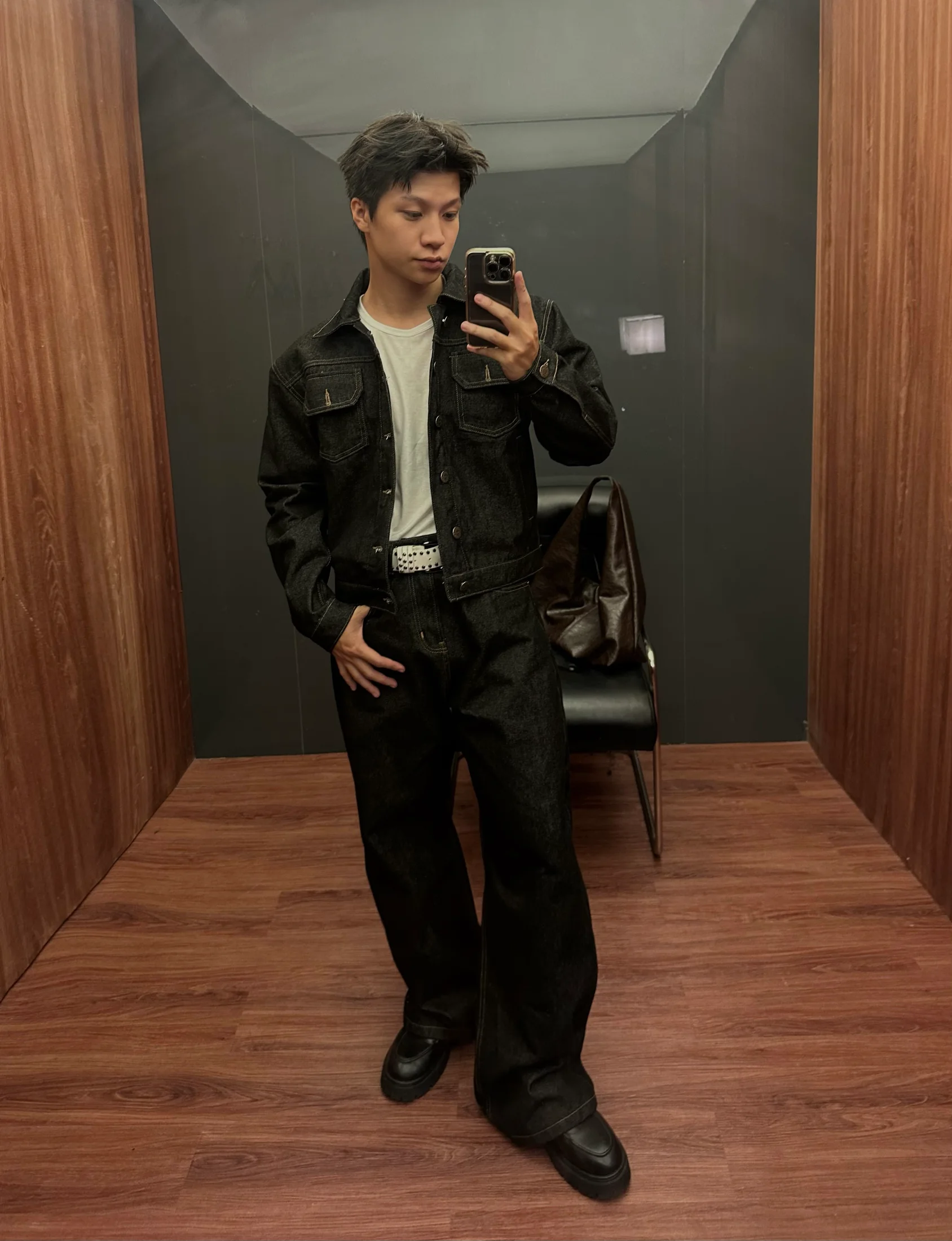 Full-length mirror portrait of Nguyễn Khánh Hưng in a coordinated denim look